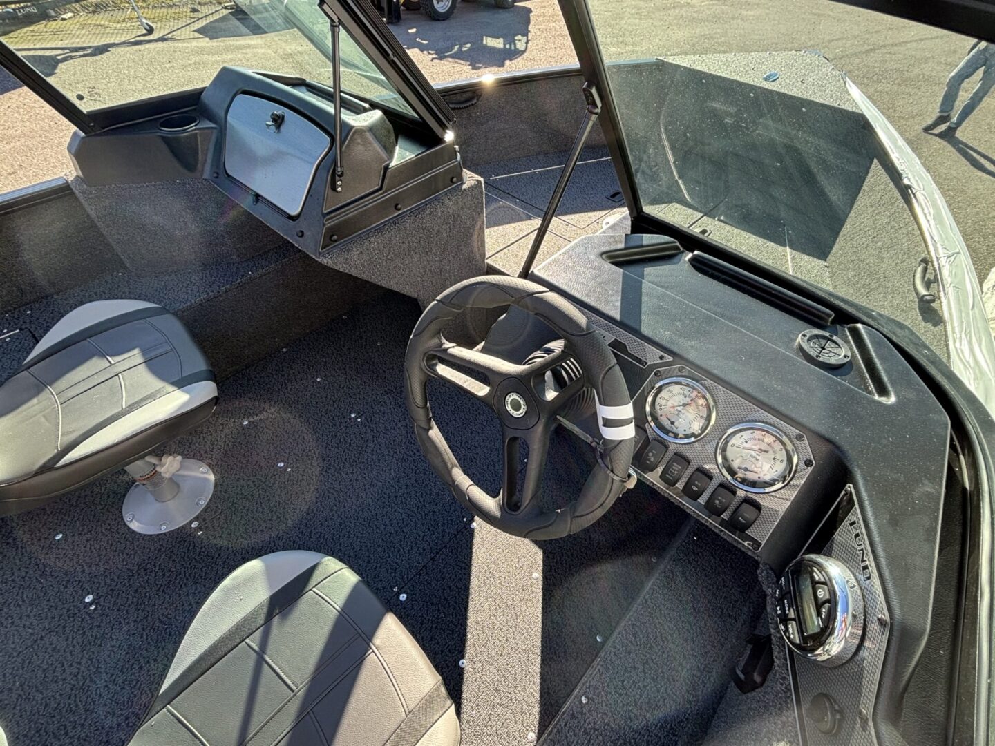 Interior of a compact, vintage vehicle with a simple dashboard and seating.