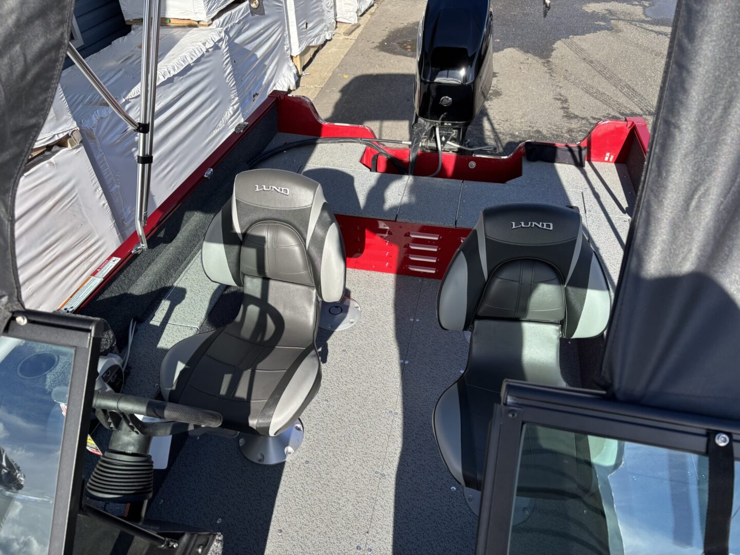 Modern boat seats with sleek black and gray design and red accents.