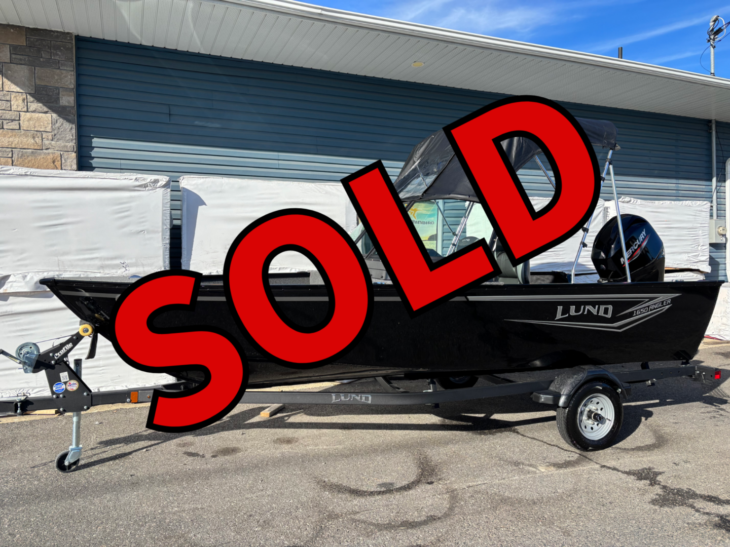 Black Lund boat on trailer marked SOLD