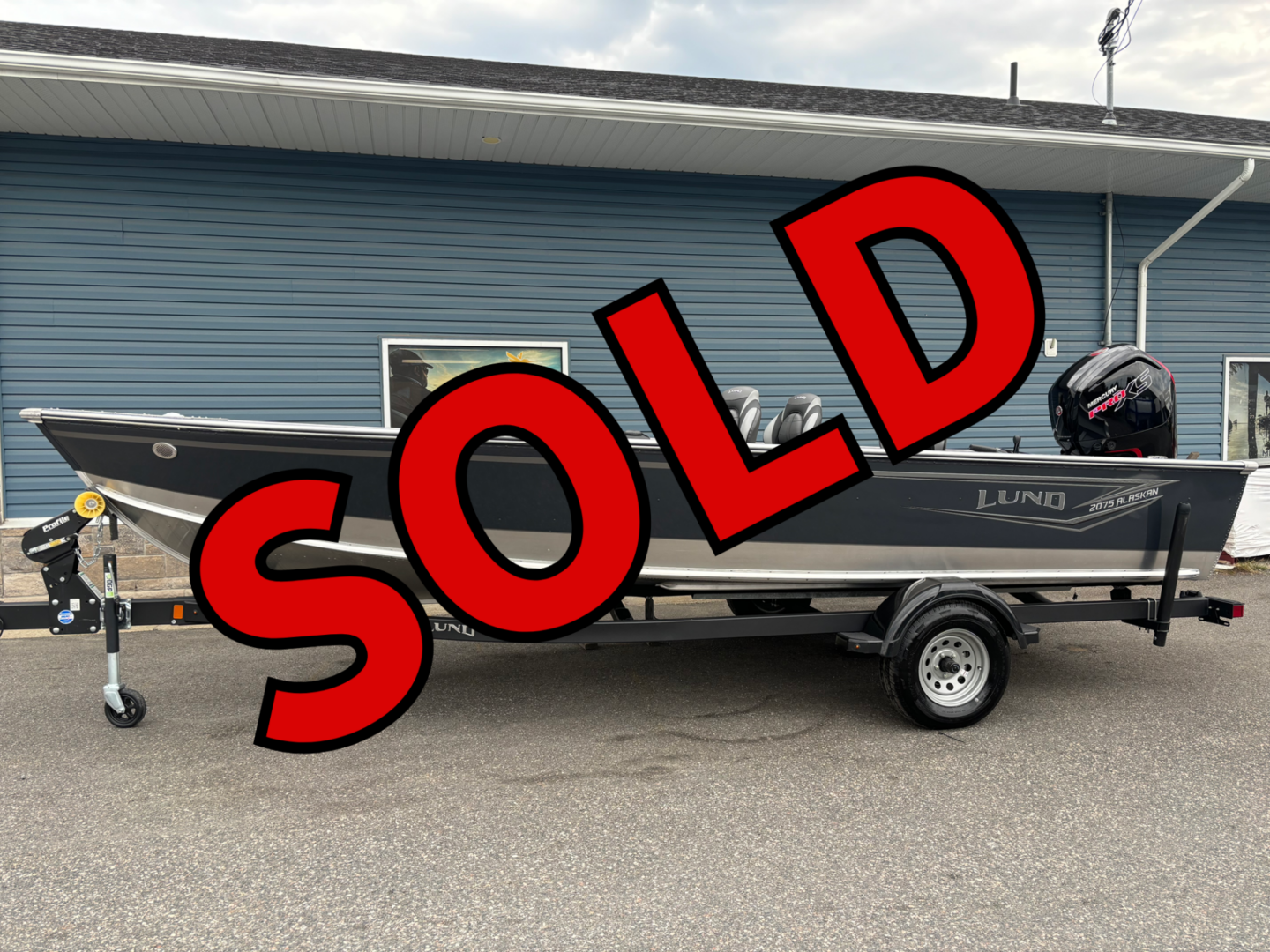 Gray Lund boat on trailer marked SOLD
