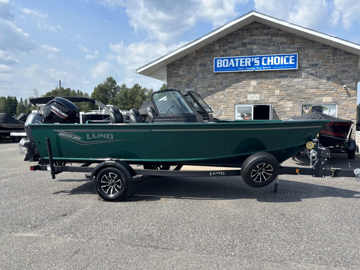 Green fishing boat parked outside Boater's Choice store.