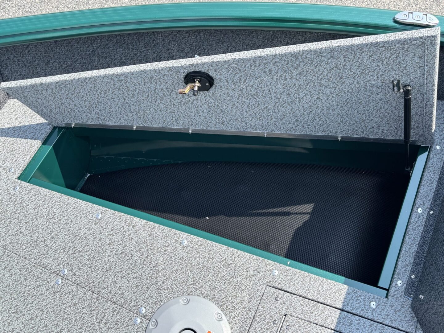 Open storage compartment inside a boat seating area.