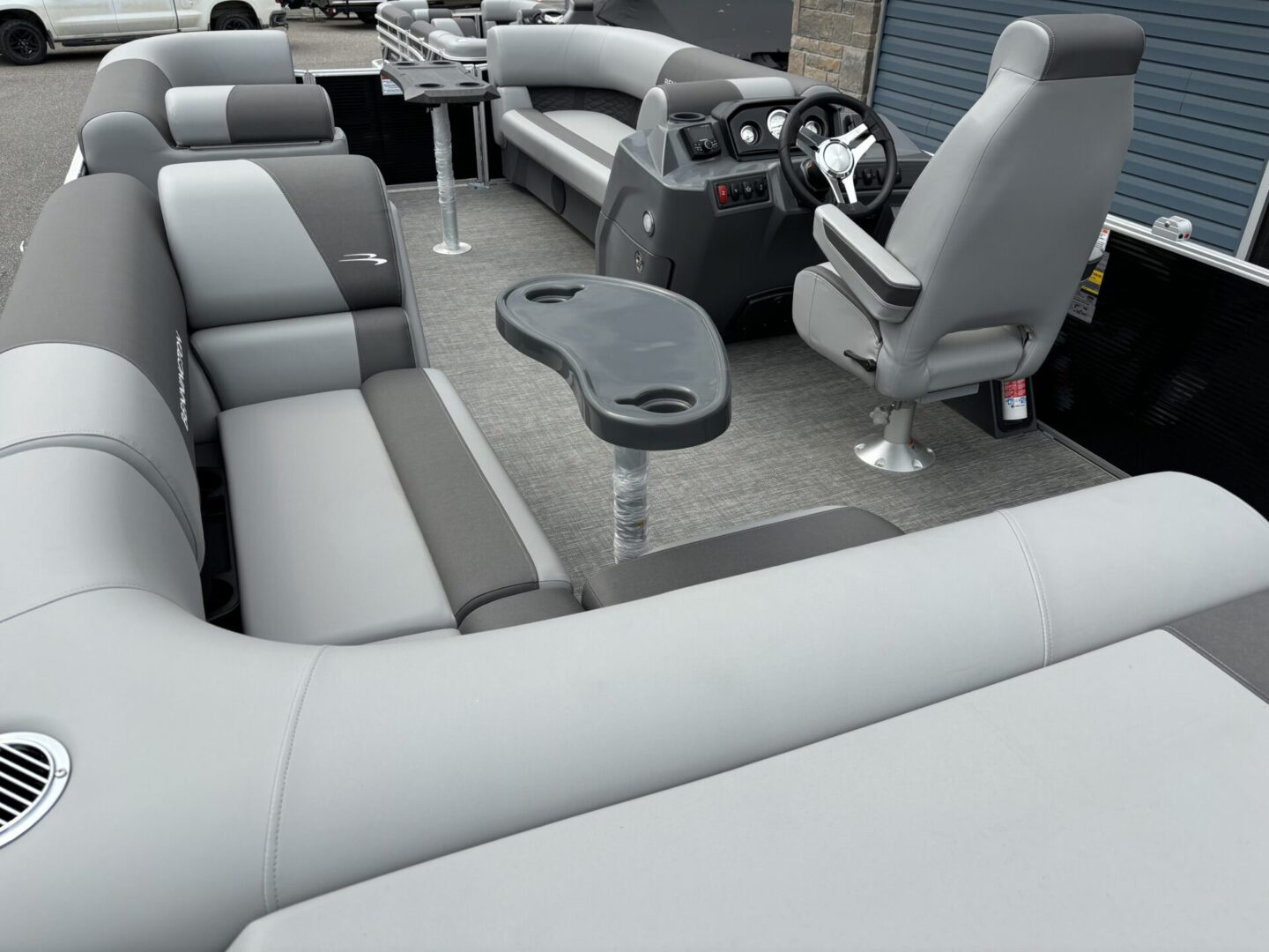Modern pontoon boat seating with built-in cup holders and a sleek design.