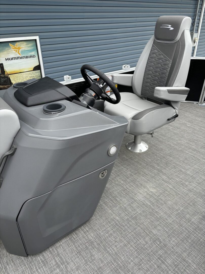 Modern boat helm with steering wheel and captain's chair.