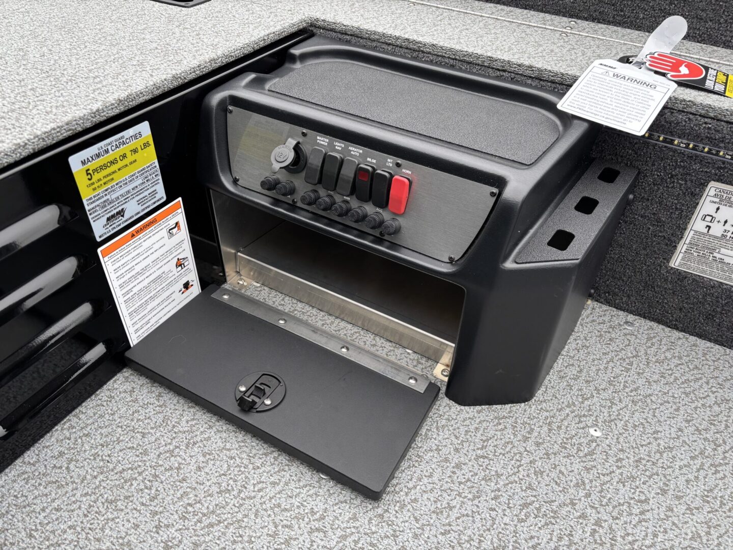 Open electrical panel with switches inside a vehicle or boat.