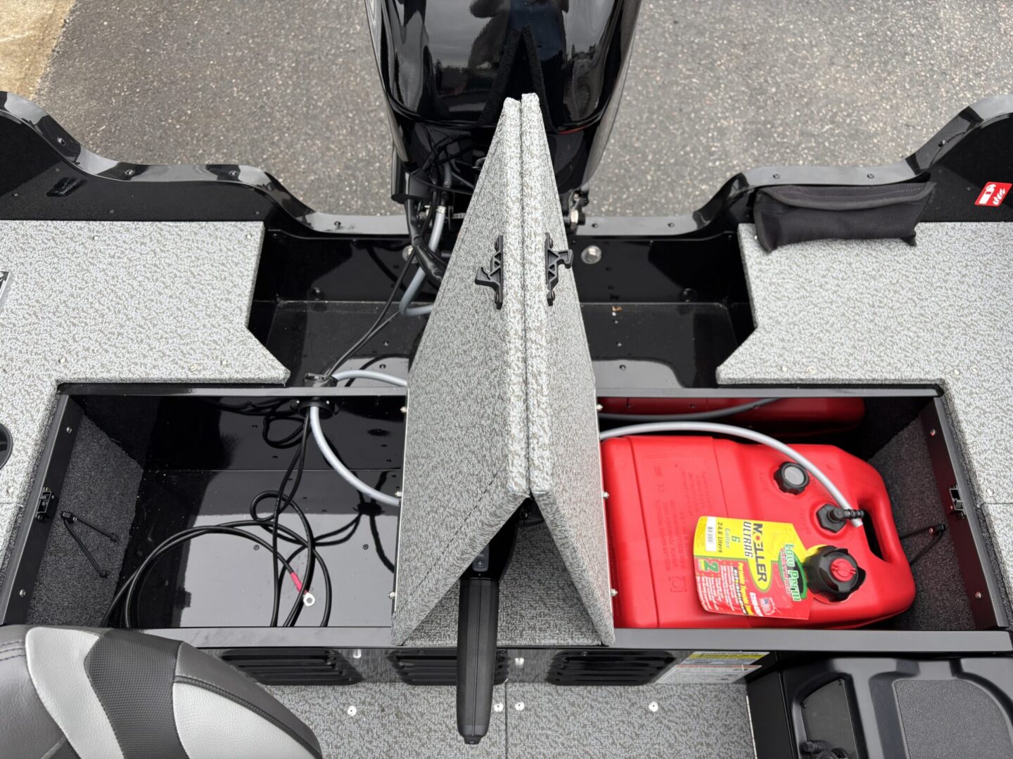 Boat motor setup with red gas container and foam blocks.