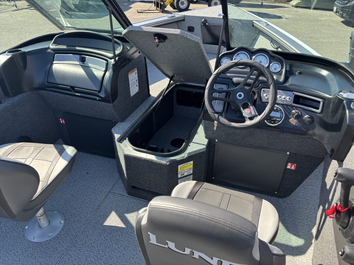 Interior of a modern fishing boat with controls and storage compartments.