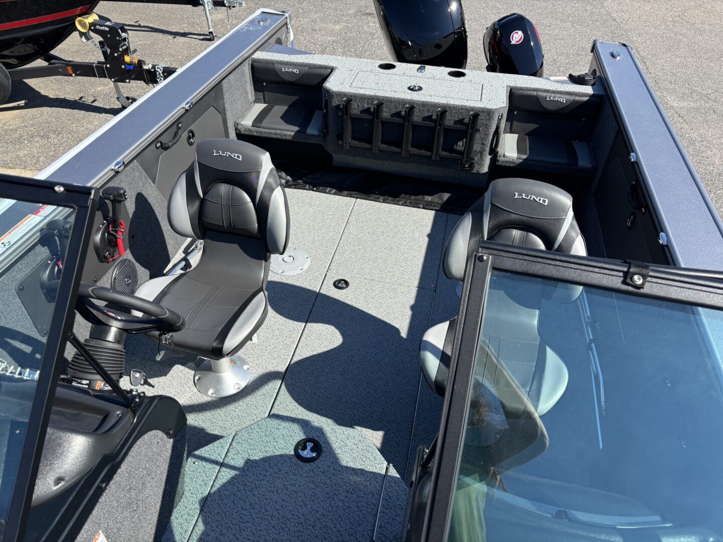 Interior view of a fishing boat with seats and equipment.
