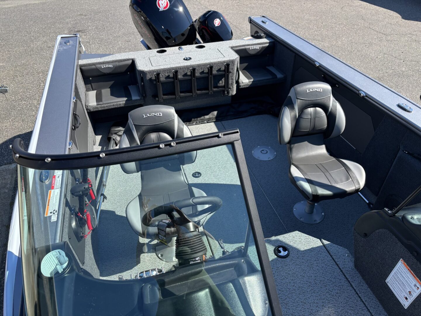 Interior of a boat with seating and steering console.