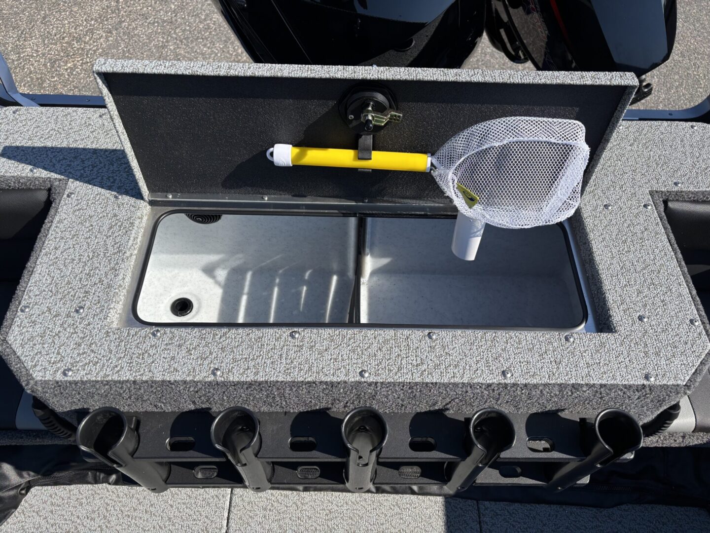 Fishing boat with a built-in live bait tank and net.