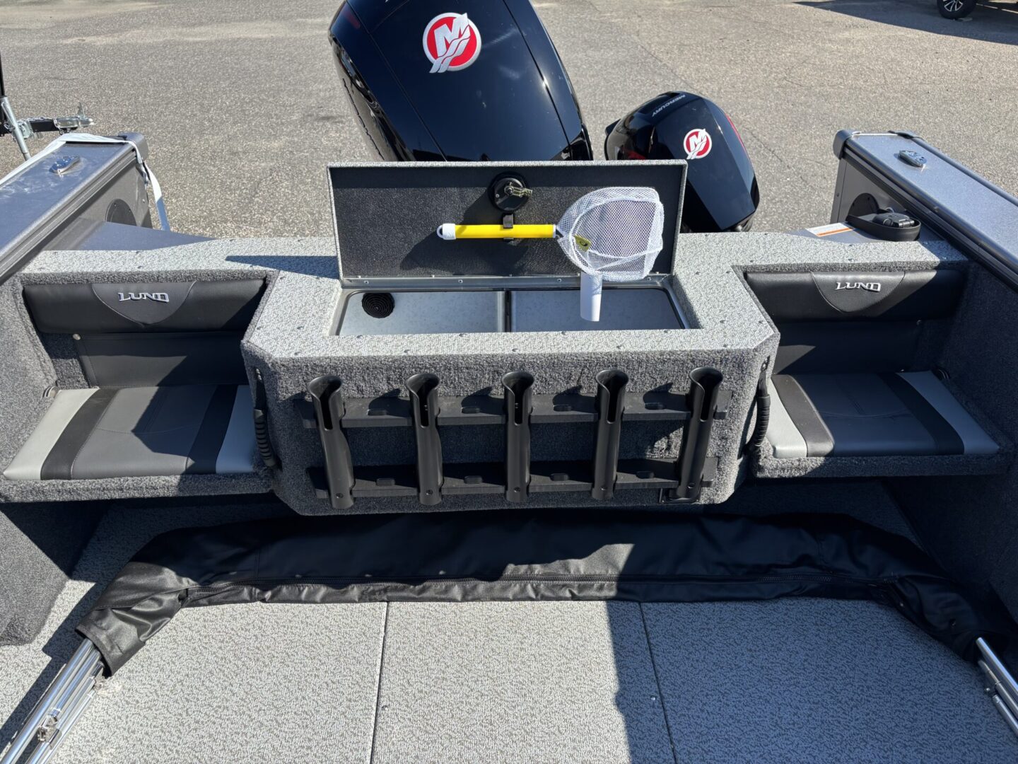 Boat motor mount with two Mercury outboard engines and storage compartments.