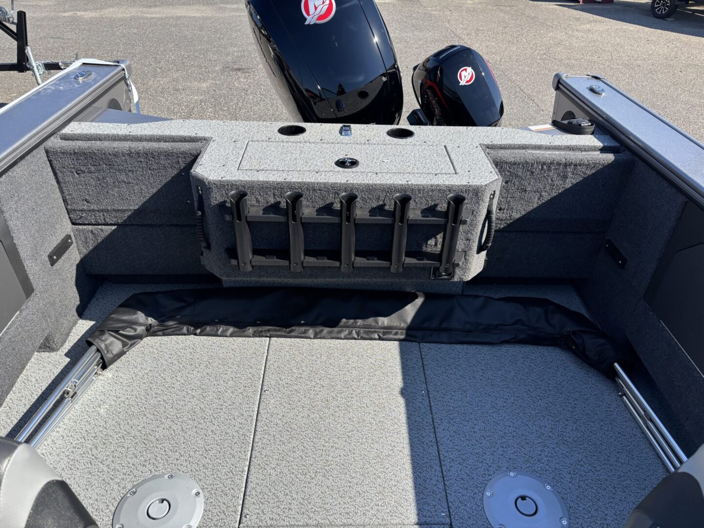 Fishing rod holder mounted on a boat deck with outboard motors.
