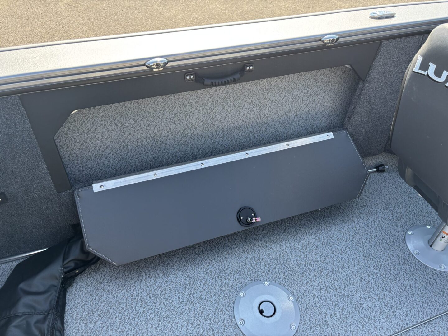 Car trunk with a folded parcel shelf inside.
