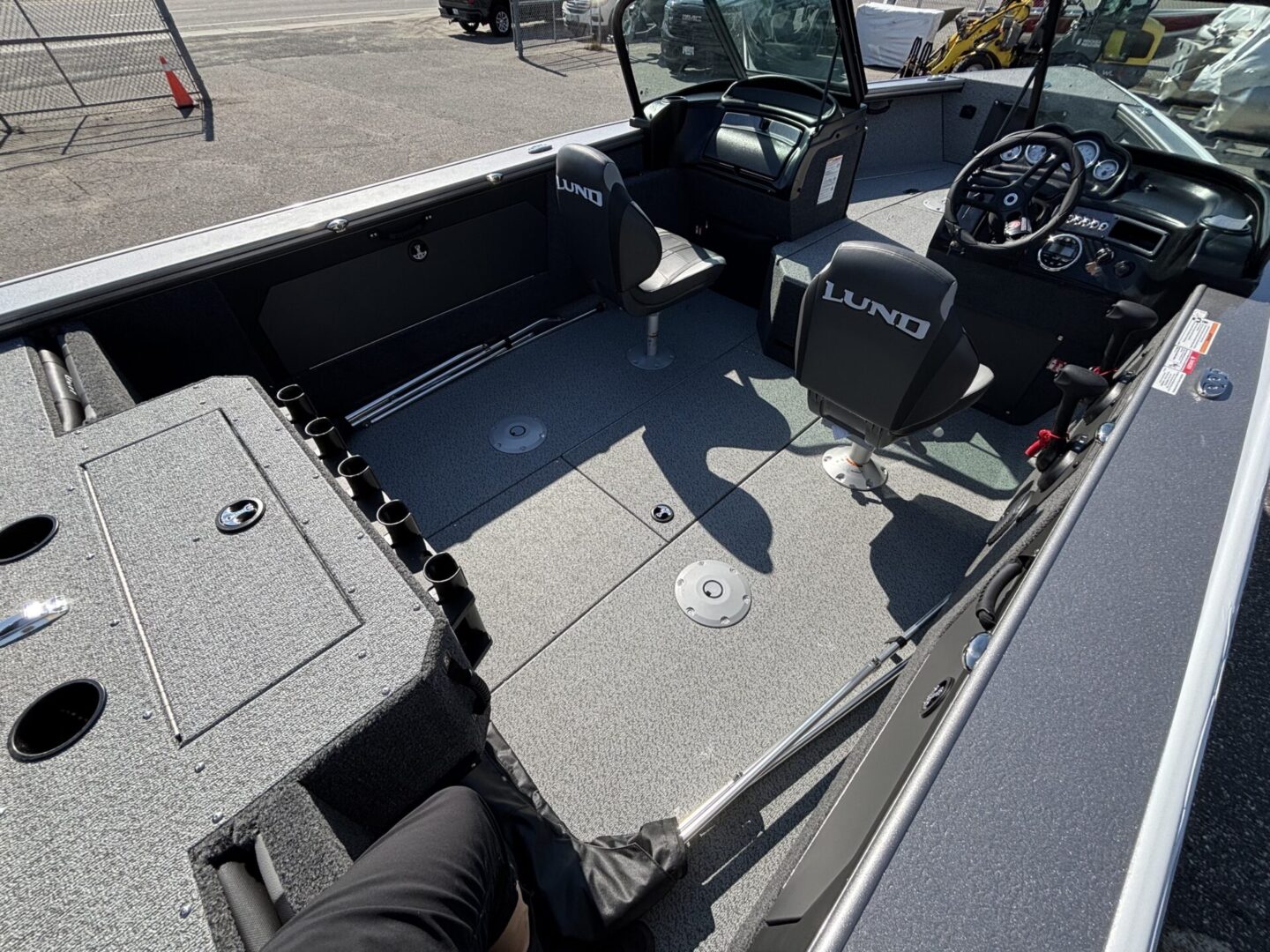 Spacious boat deck with seating and storage compartments.