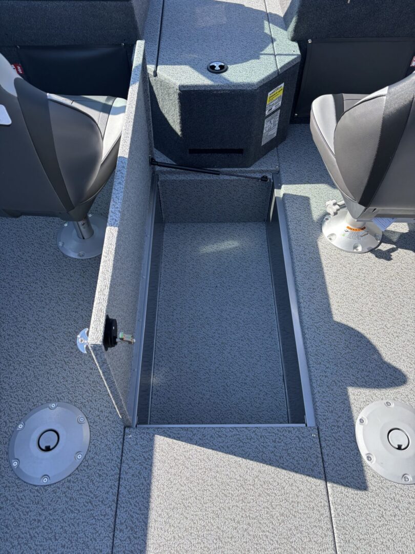 Open storage compartment in a boat deck between seats.