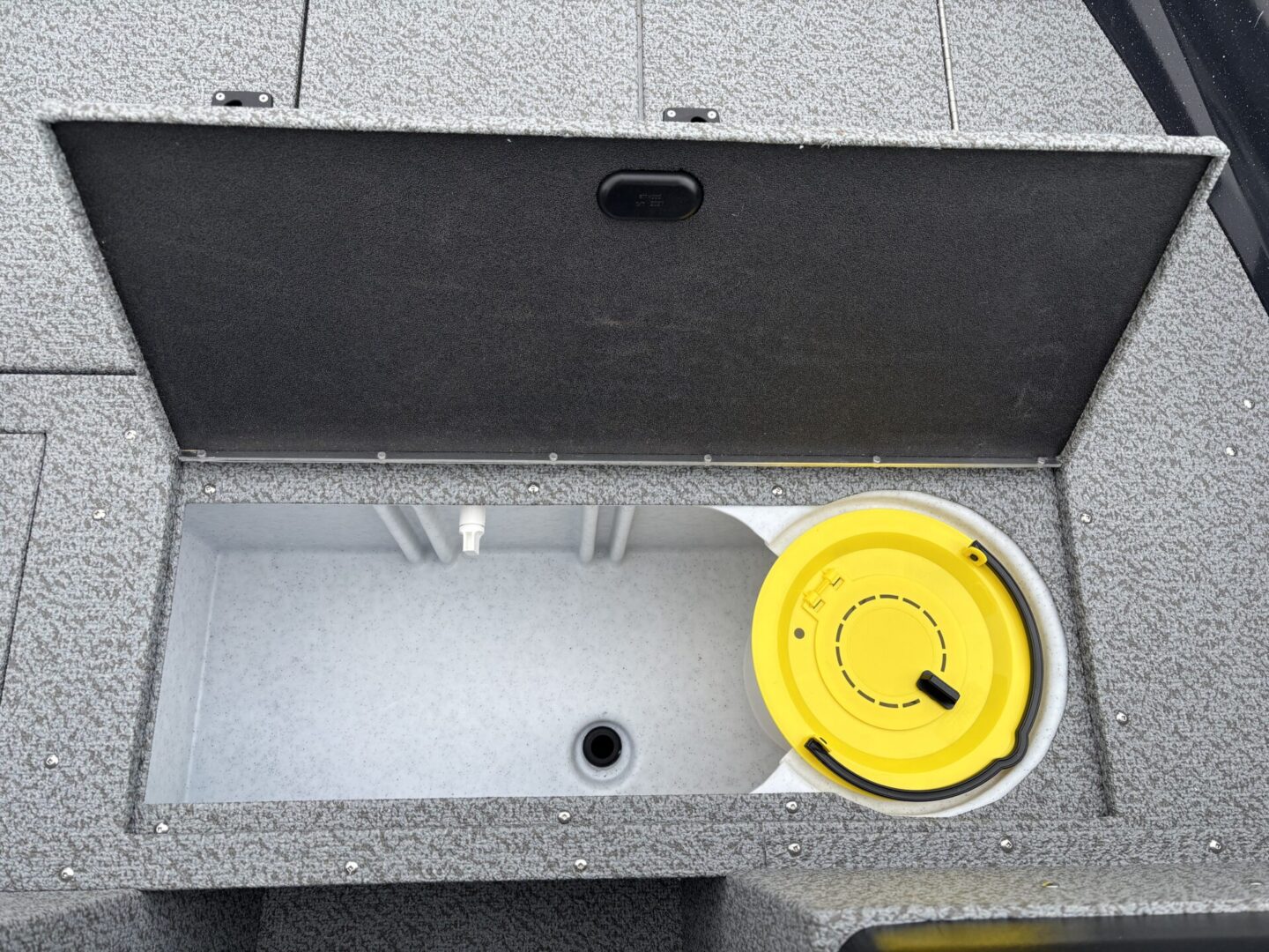 Open empty cooler with a yellow circular lid inside.