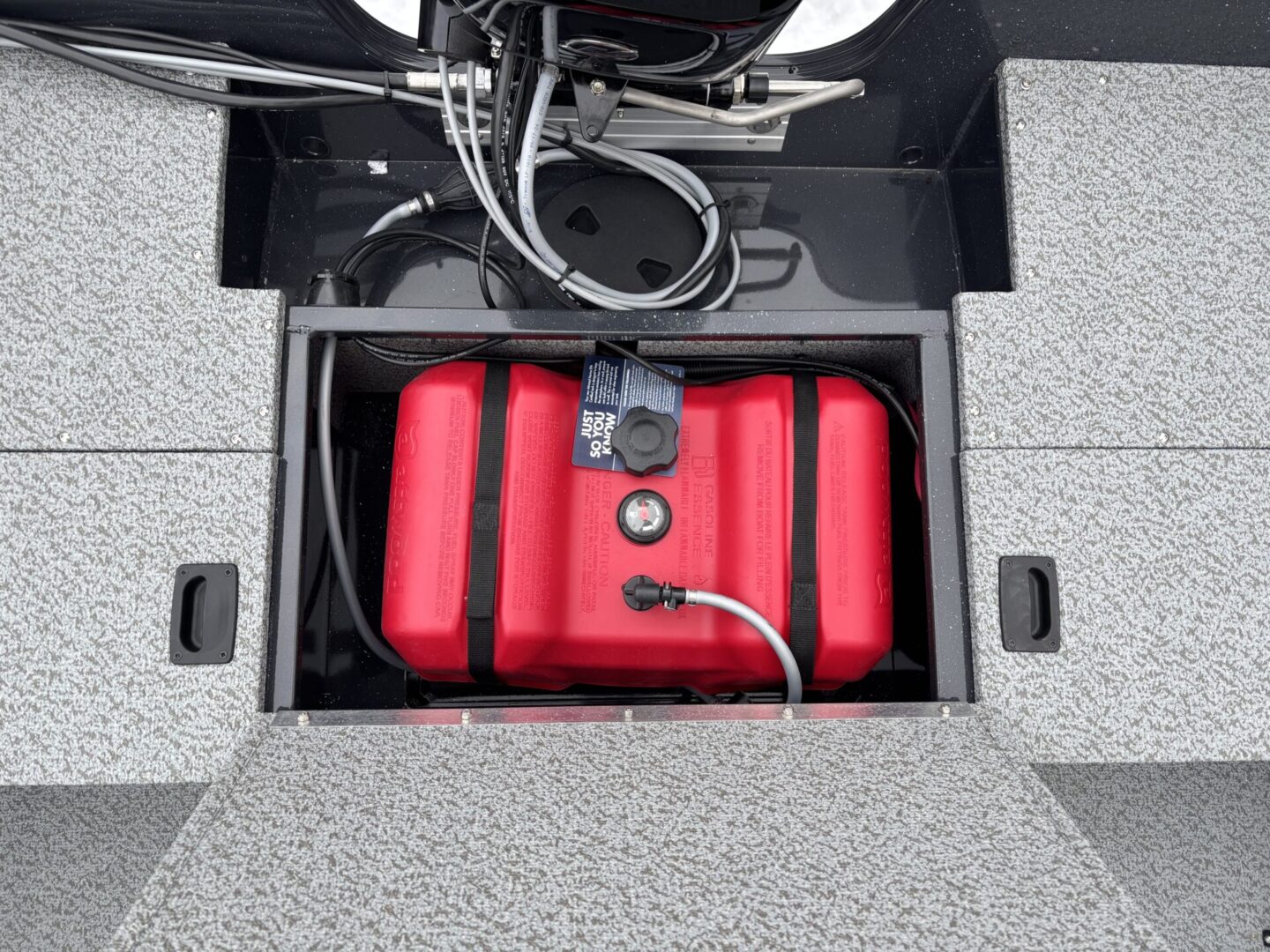 Red battery packs secured in a compartment with cables connected.