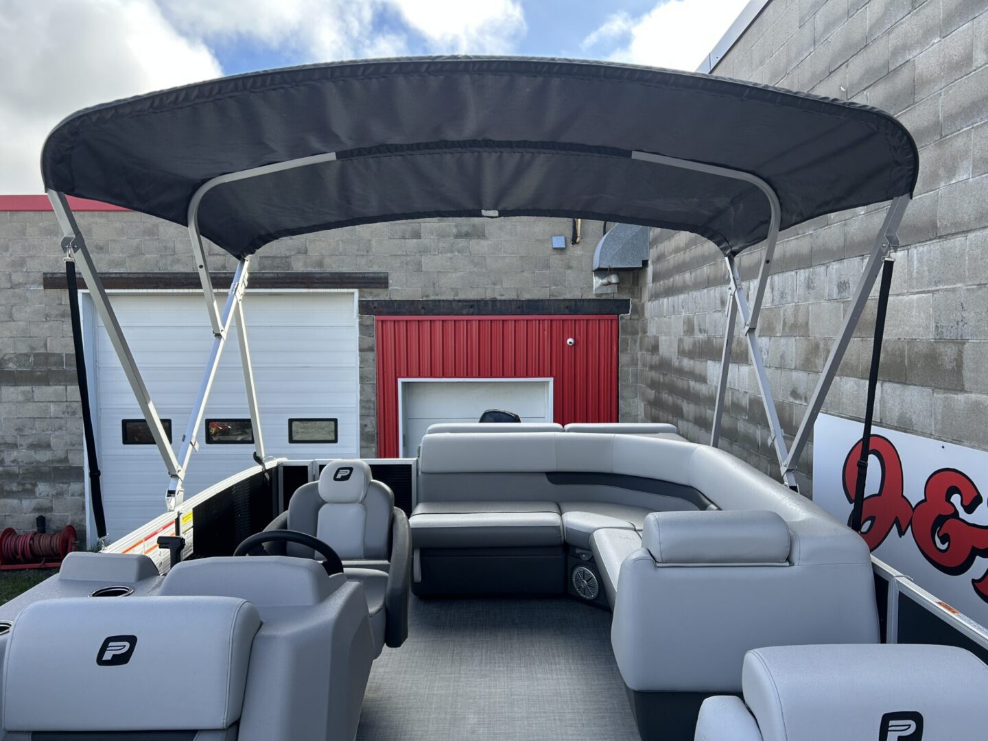 Pontoon interior with raised bimini and rear lounge