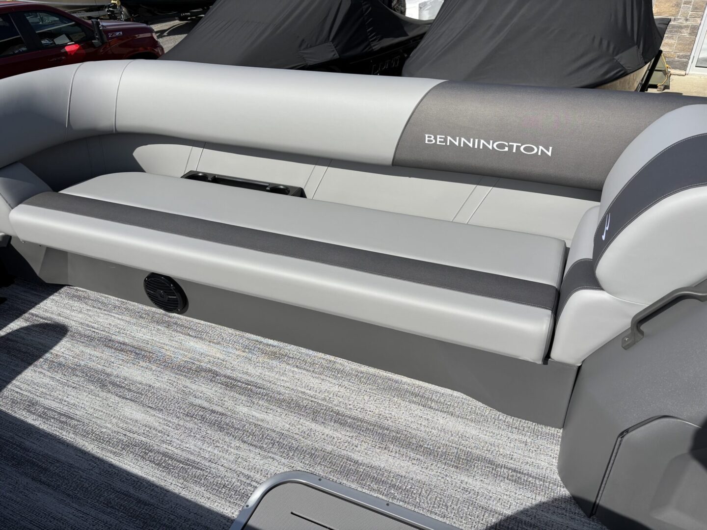 Close-up of a gray and white boat seat with 'Bennington' branding.