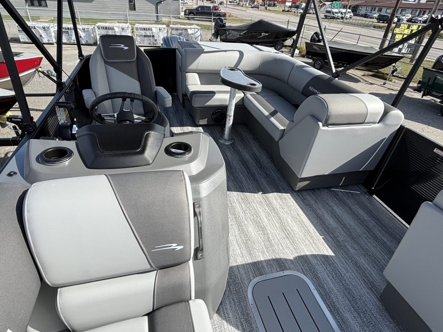 Spacious pontoon boat seating with modern gray and white upholstery.