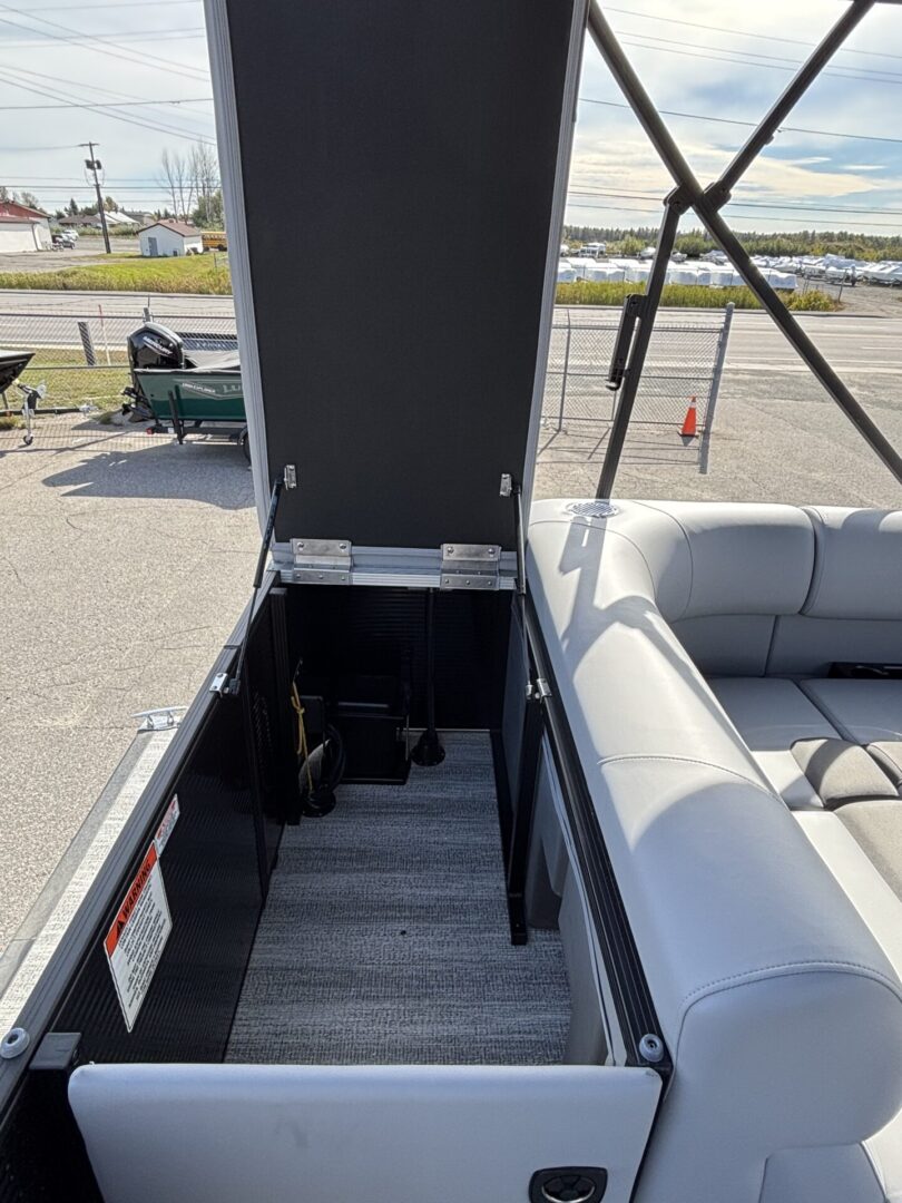 Open hatch revealing stairs leading down on a boat.