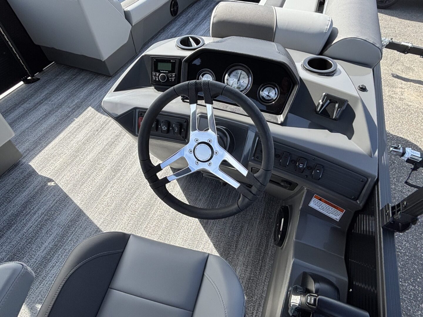 Modern boat steering console with sleek design and gauges.