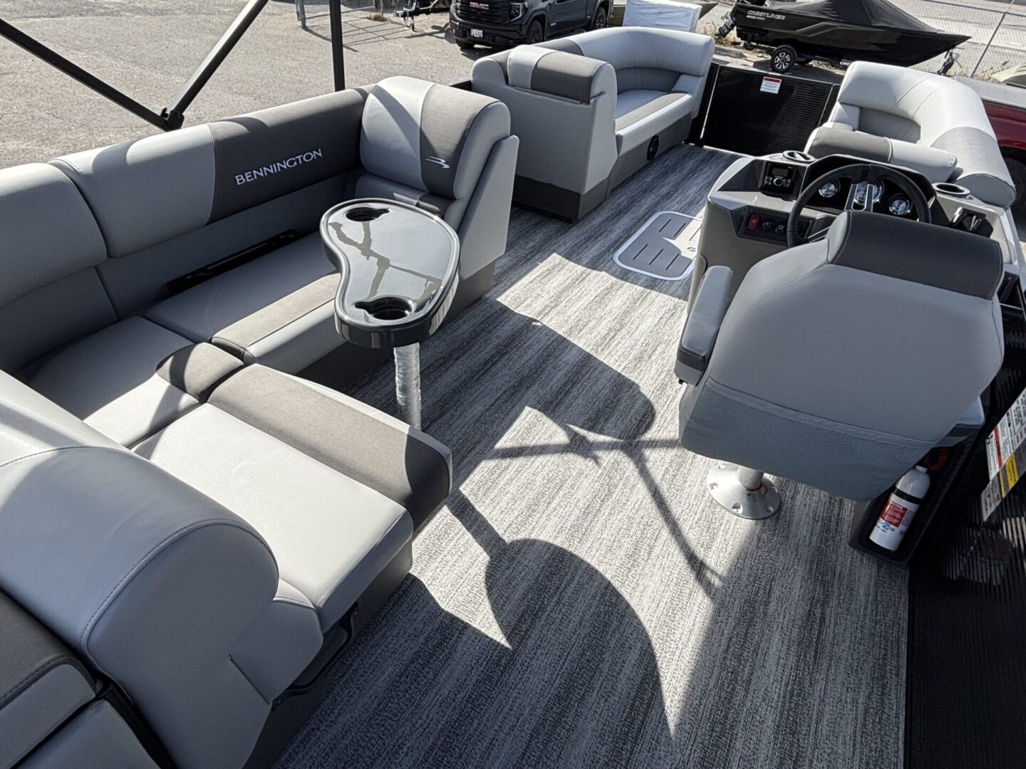 Modern boat interior with sleek gray seating and a small round table.