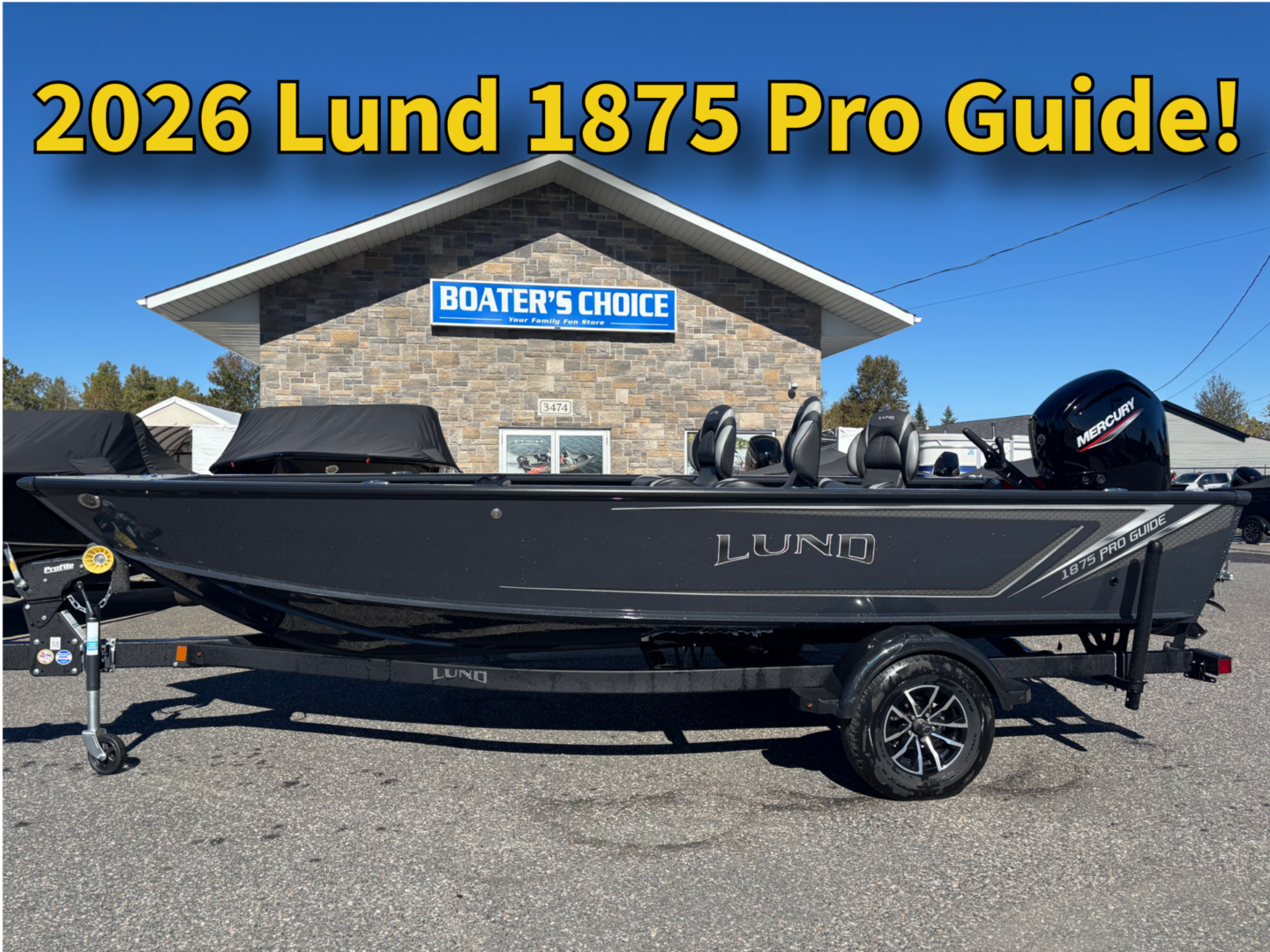 A sleek 2026 Lund 1875 Pro Guide fishing boat on a trailer.