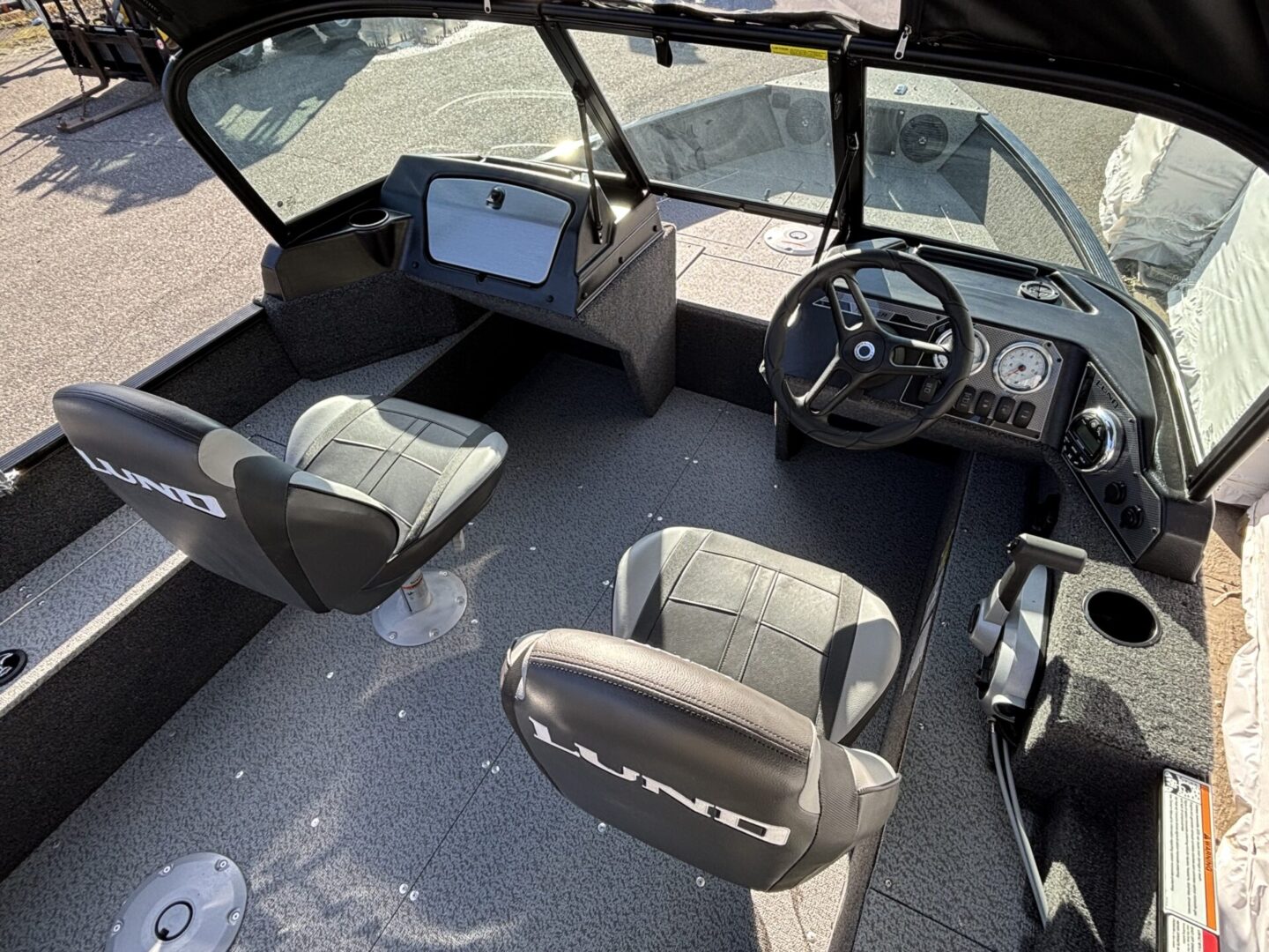 Interior view of a modern motorboat's helm and seating area.