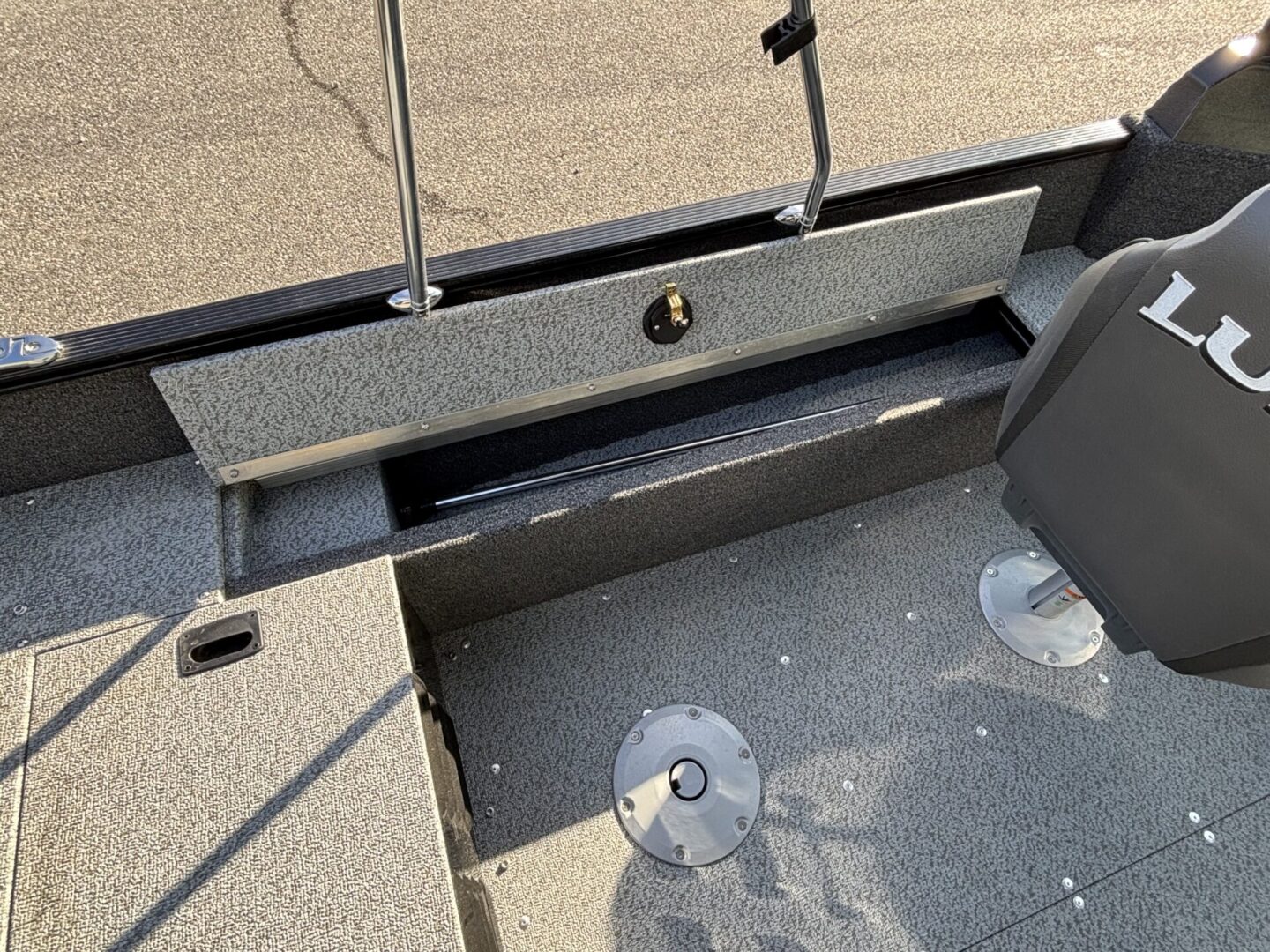 Open glove compartment in a vehicle showing a small storage space.