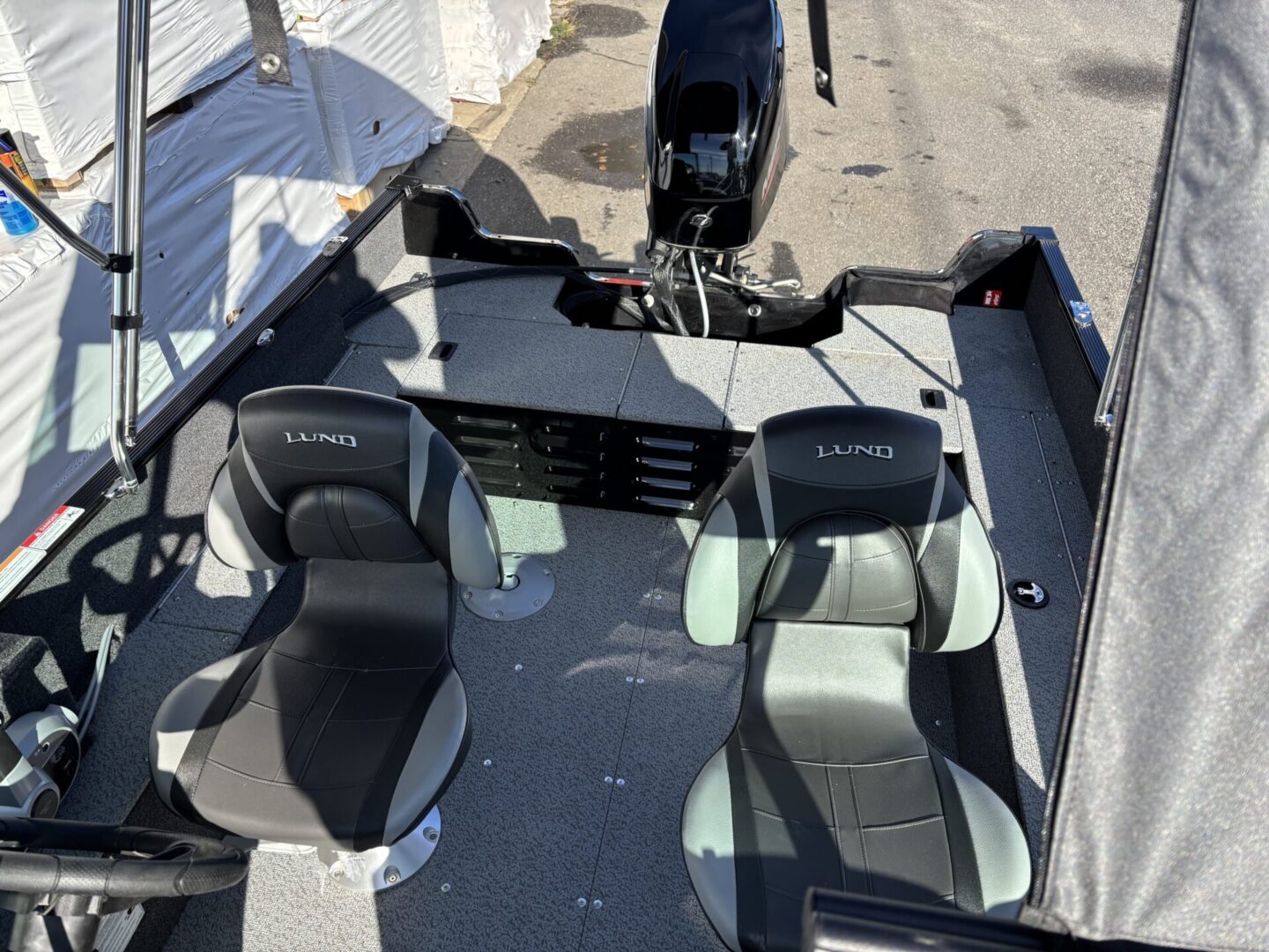 Top view of a boat interior with two seats and mounted motor.
