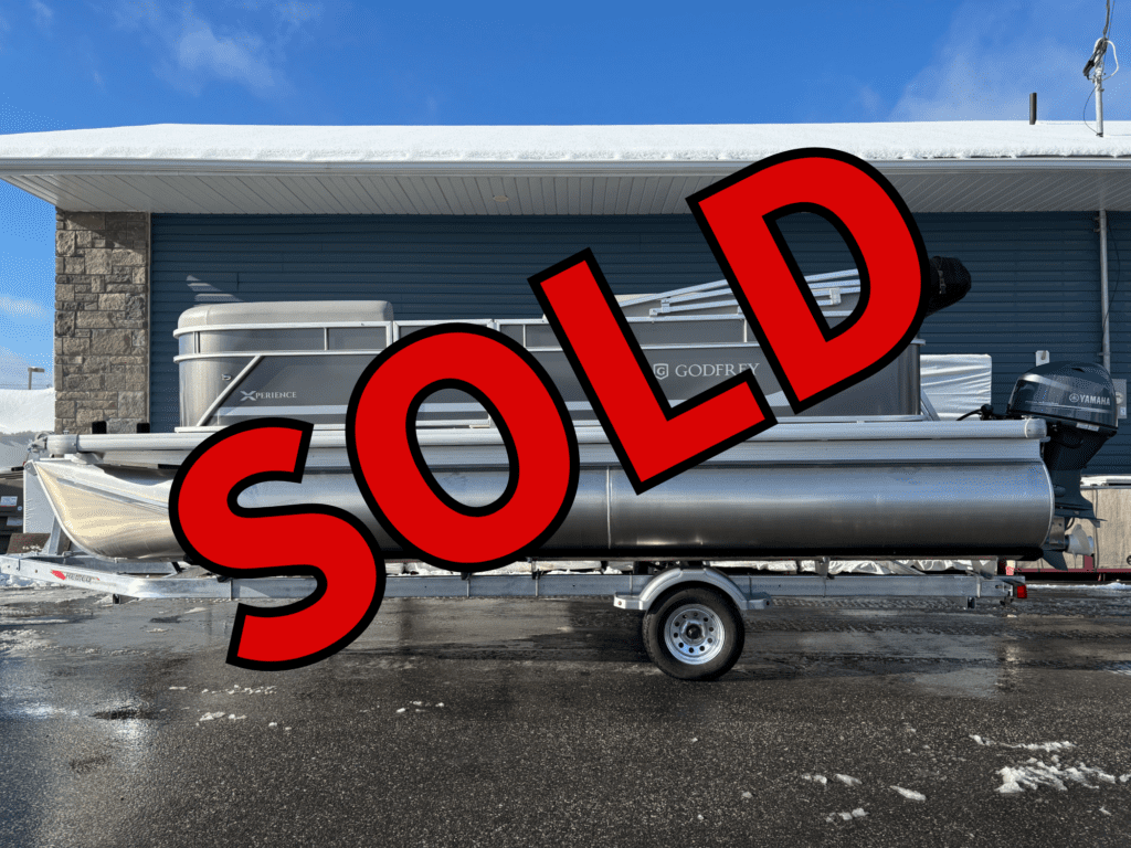 Silver pontoon boat on trailer, red SOLD overlay