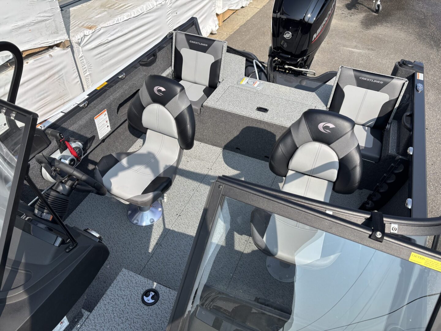 Interior view of a motorboat with seating and an outboard engine.