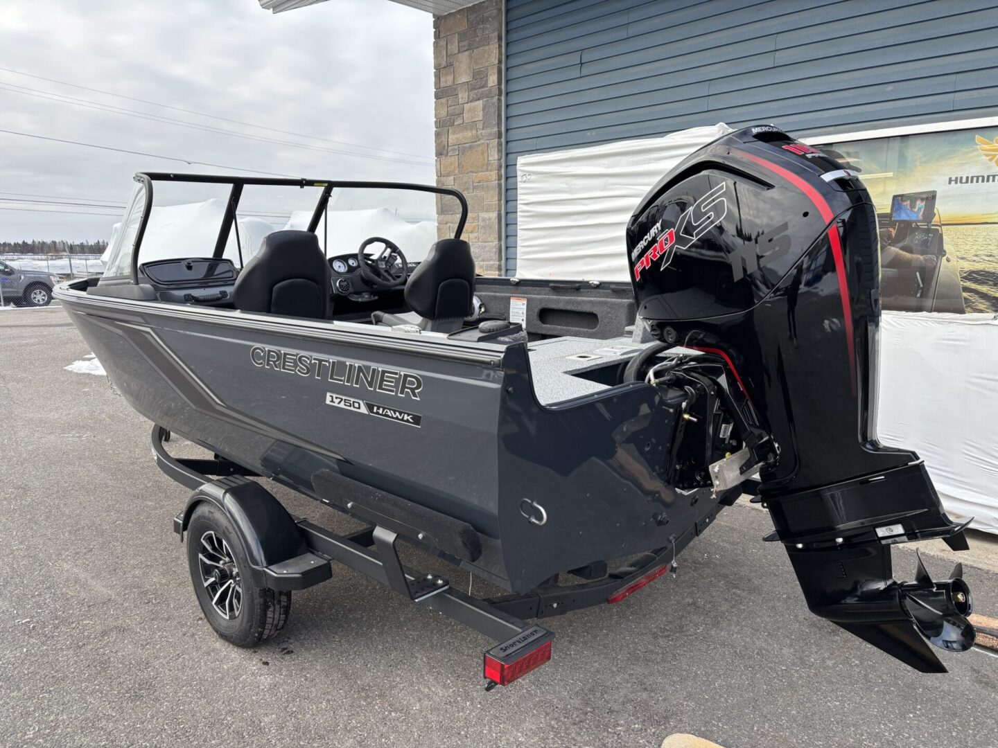 A sleek black motorboat with an outboard engine on a trailer.