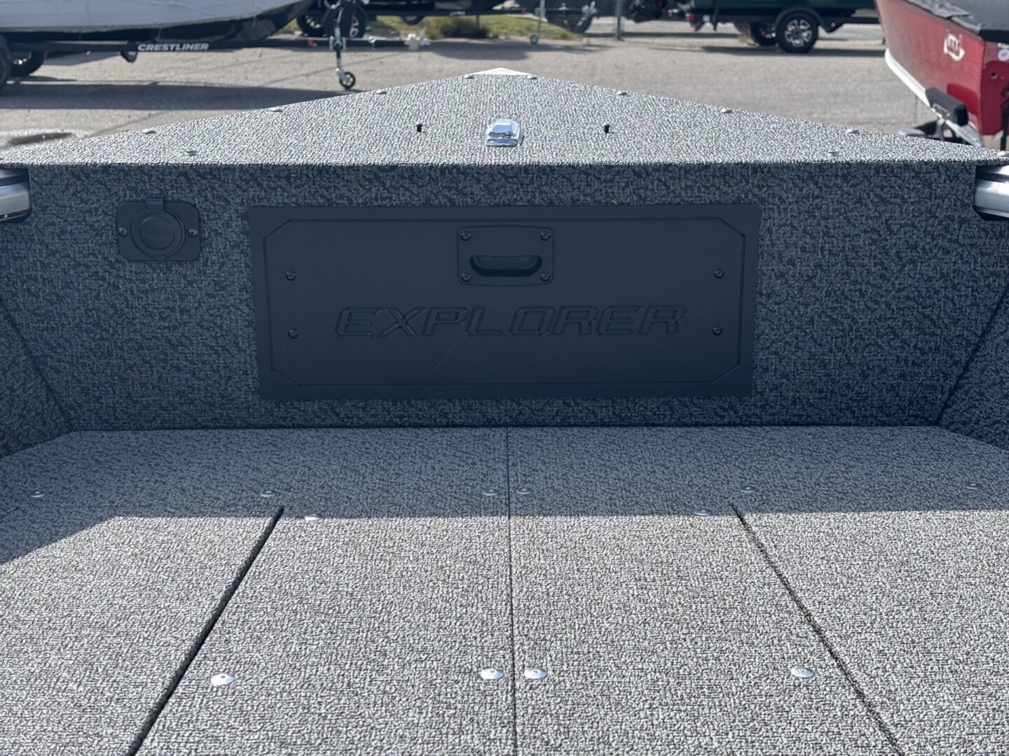 A black plaque with names engraved, set in a gray stone monument.