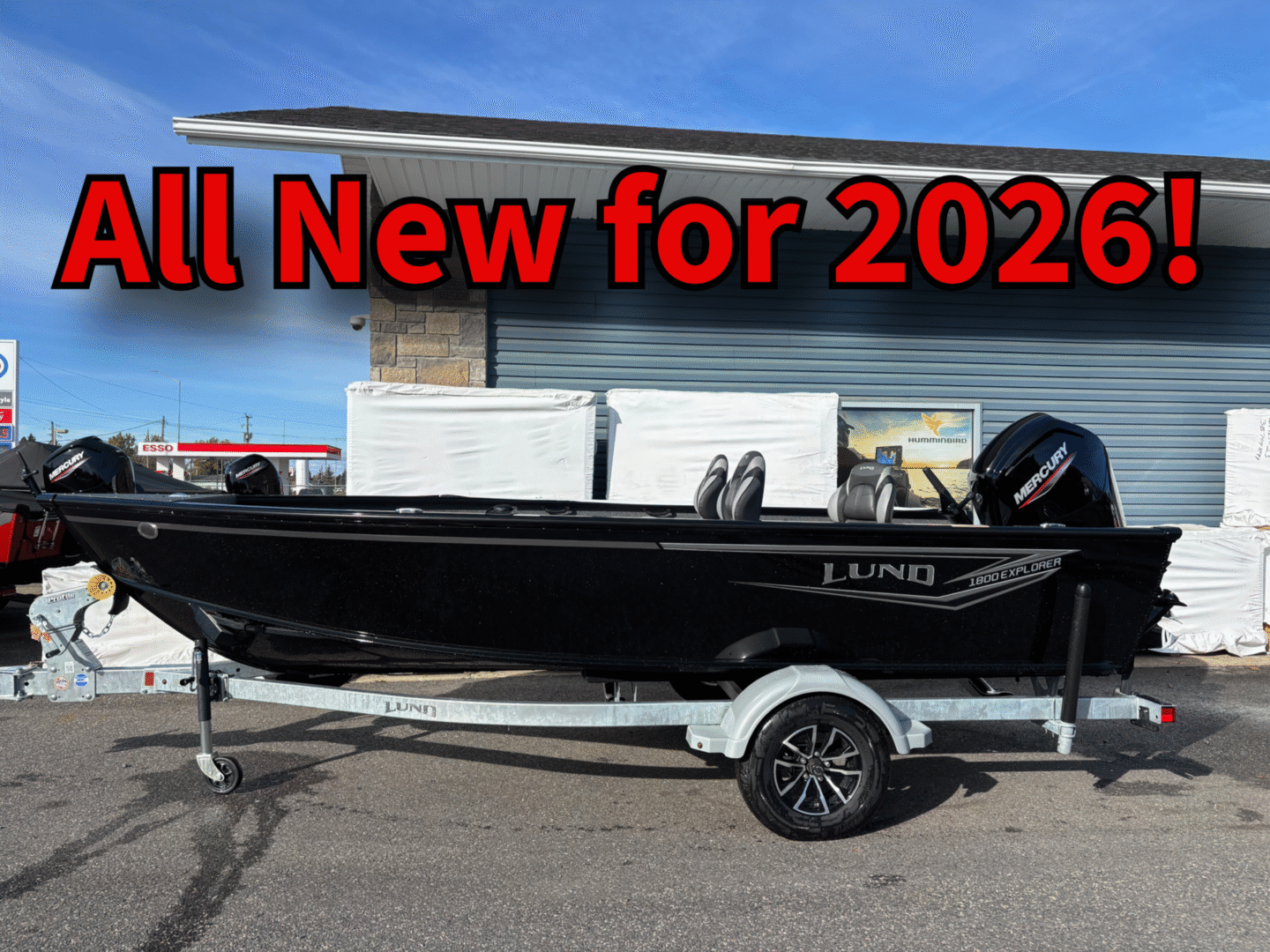 2020 model black fishing boat on trailer under blue sky.
