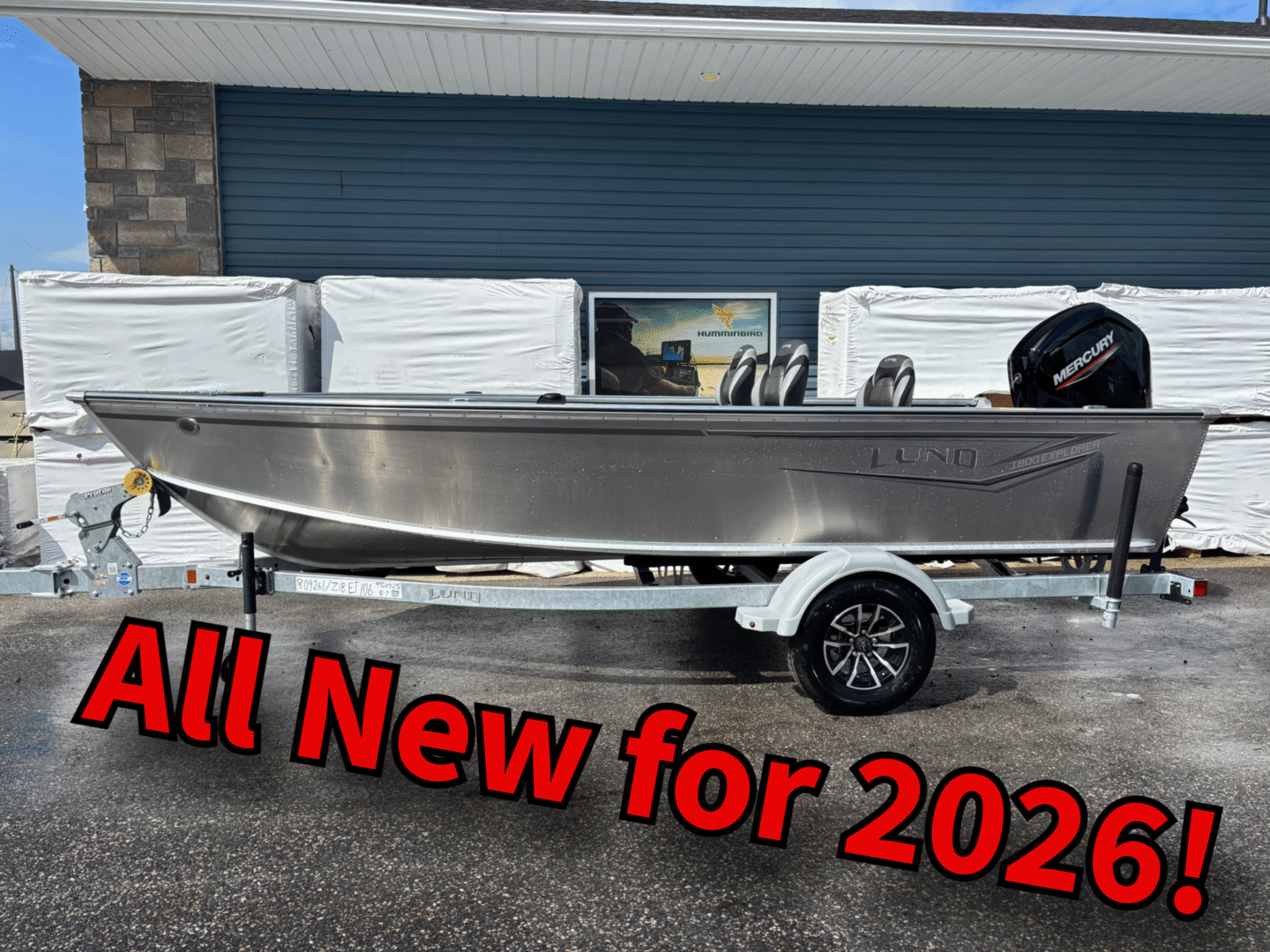 Sleek new boat on trailer with outboard motor for 2024.