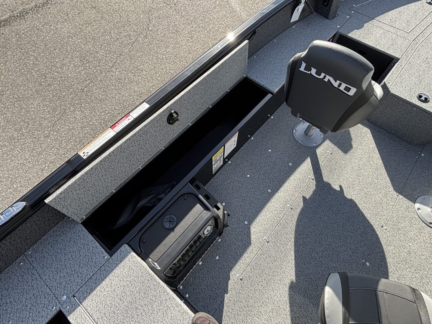 Boat interior showing a Lund seat and motor controls.