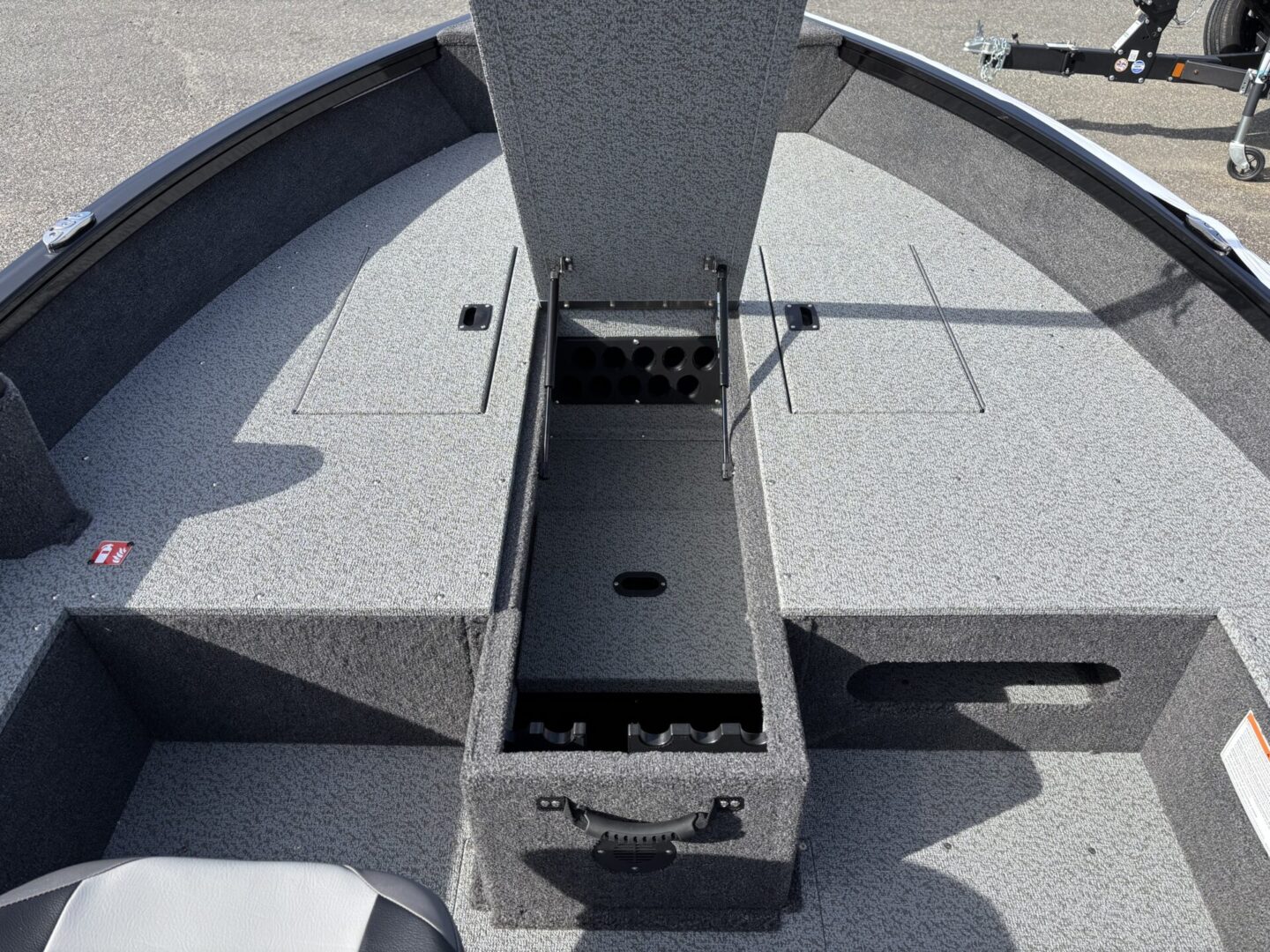 Open storage compartment on a gray boat deck.