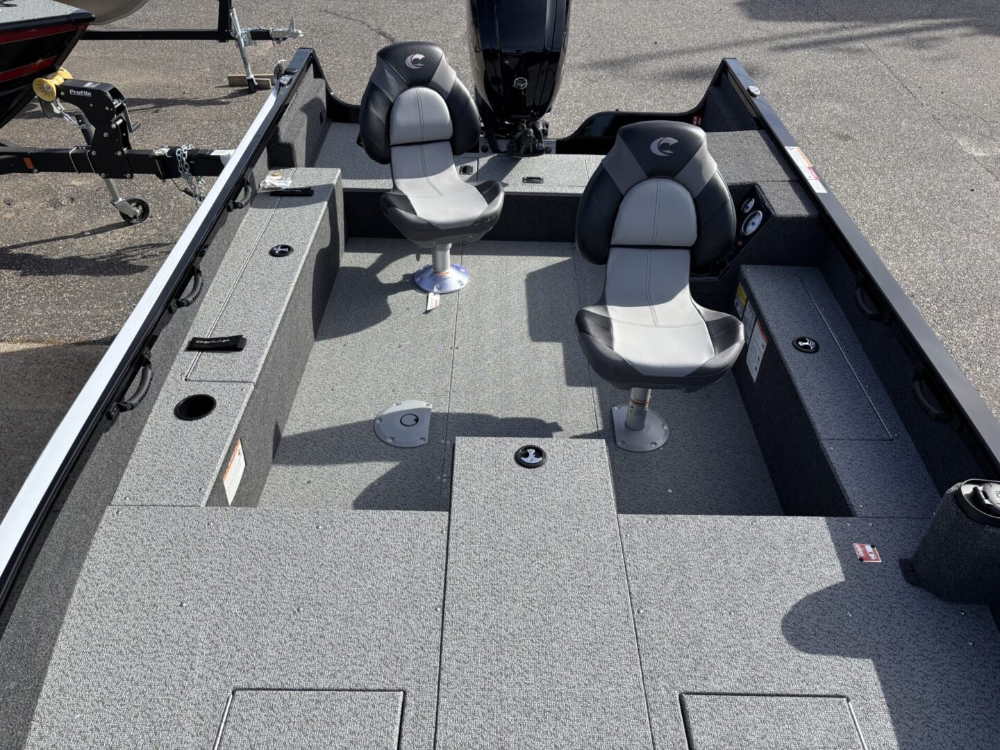Interior view of a fishing boat with seats and storage compartments.