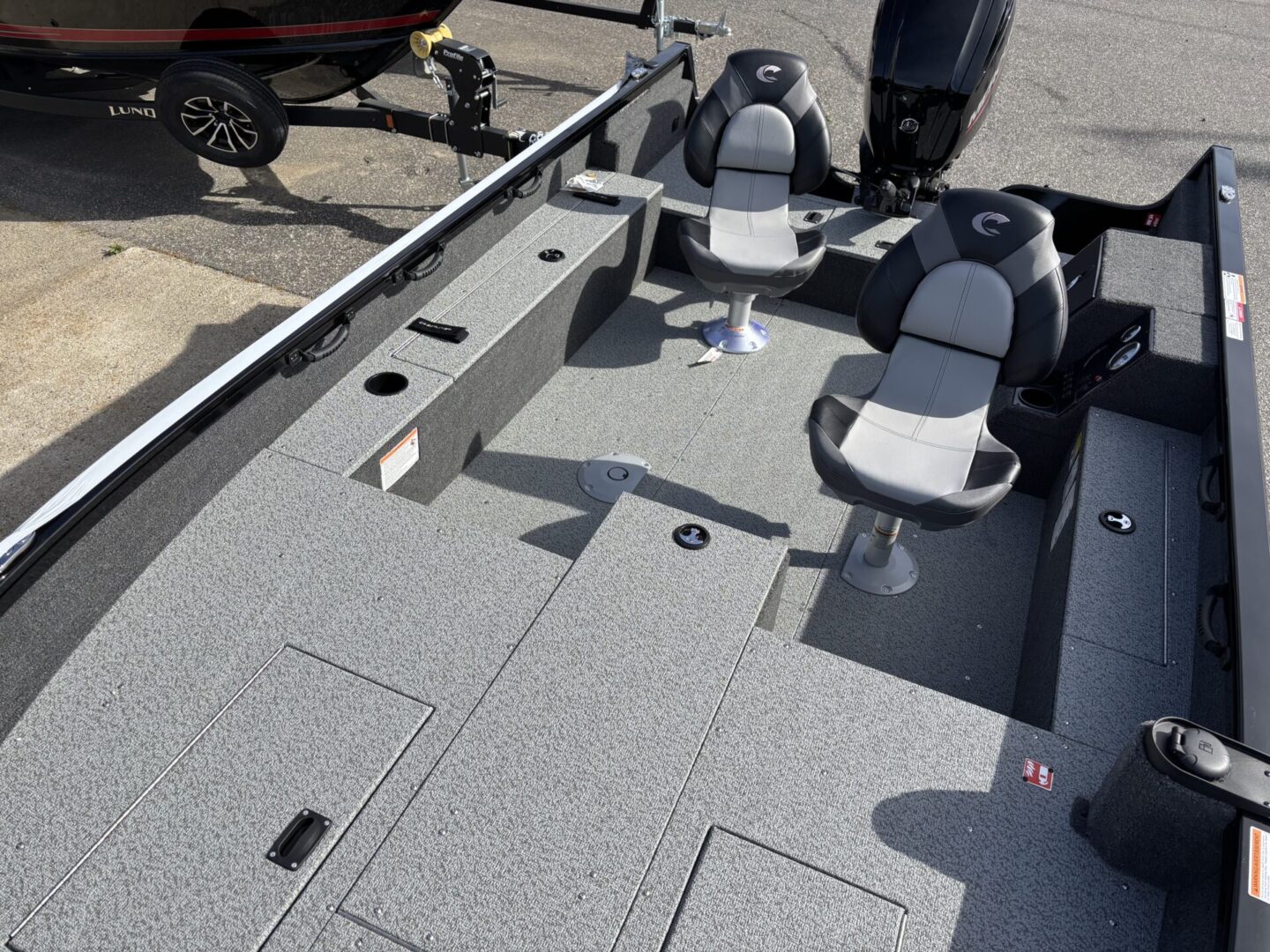 Interior view of a fishing boat with seats and storage compartments.