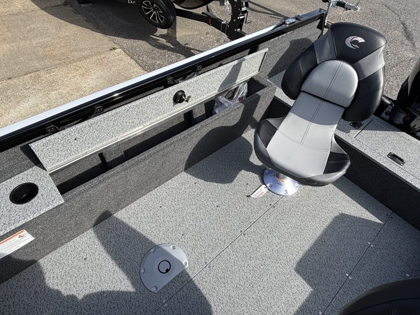 Interior of a fishing boat with seating and storage compartments.