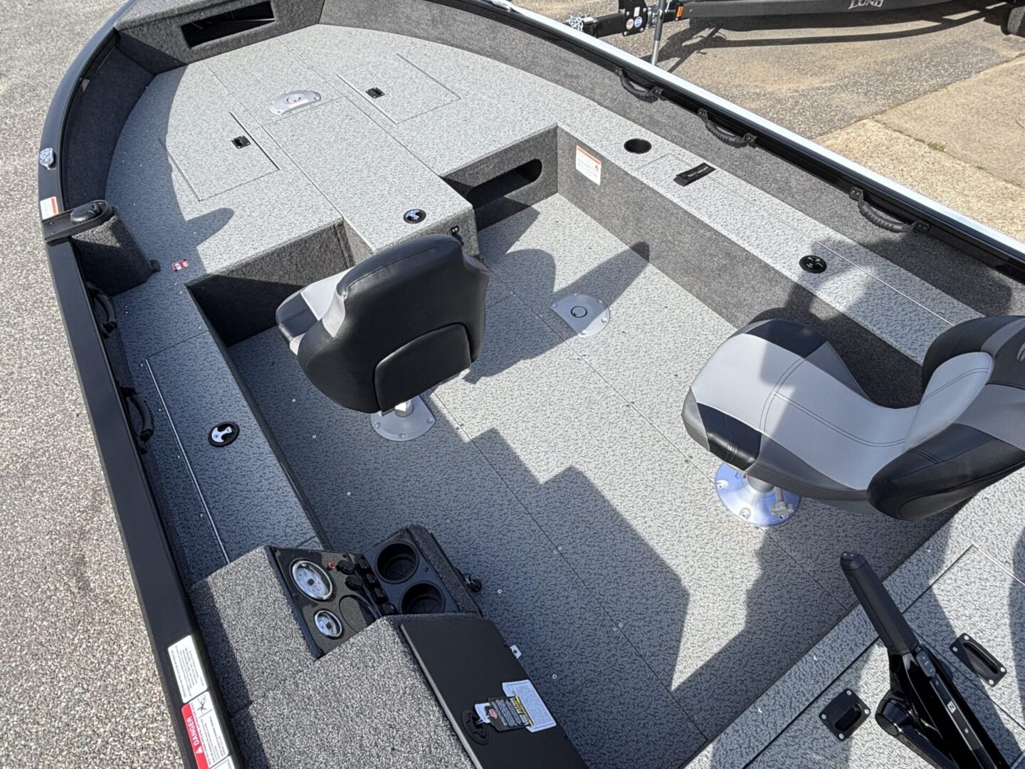 Interior of a fishing boat with seats and storage compartments.