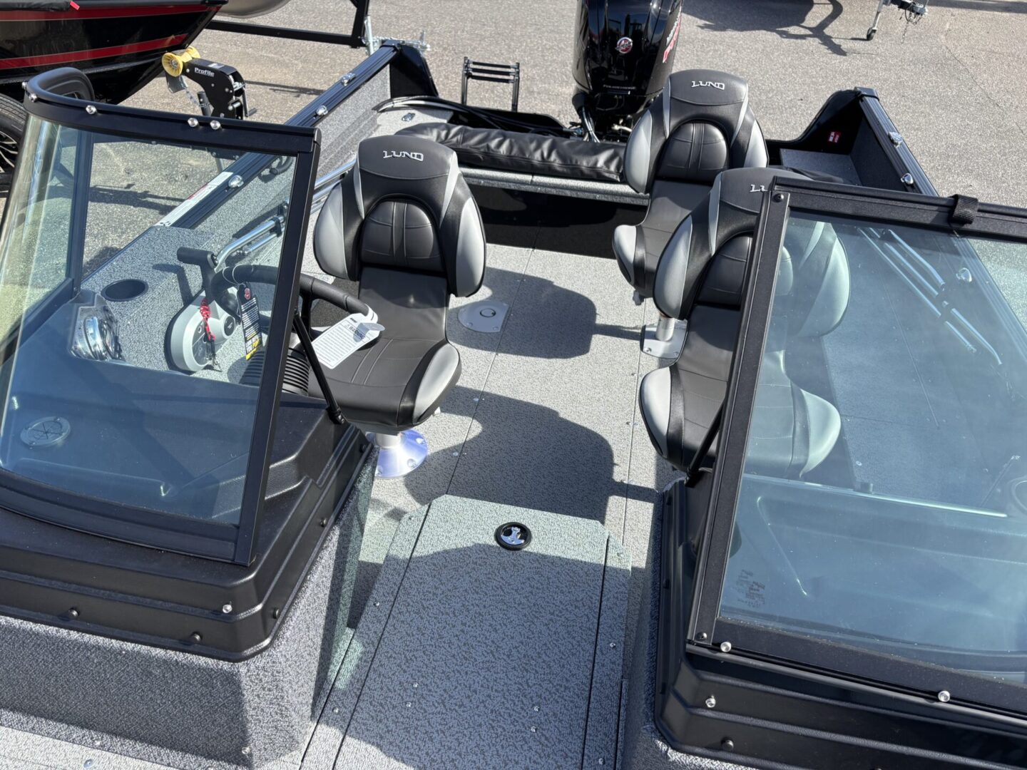 Interior view of a modern fishing boat with swivel seats and controls.