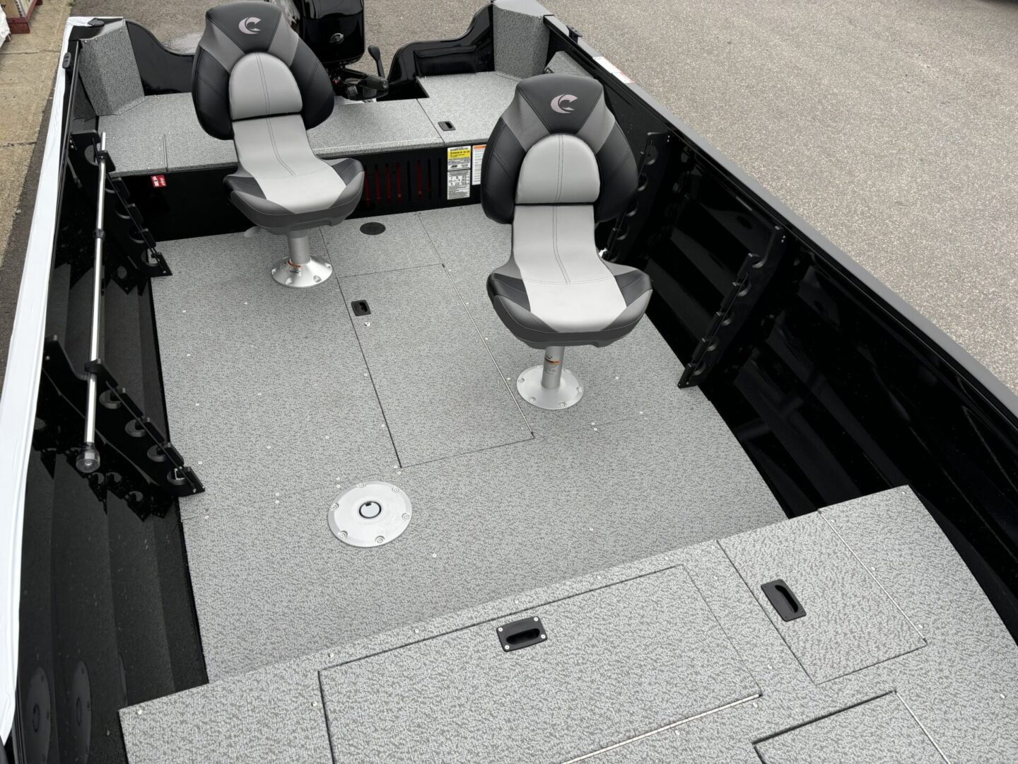 Interior of a boat with two seats and storage compartments.