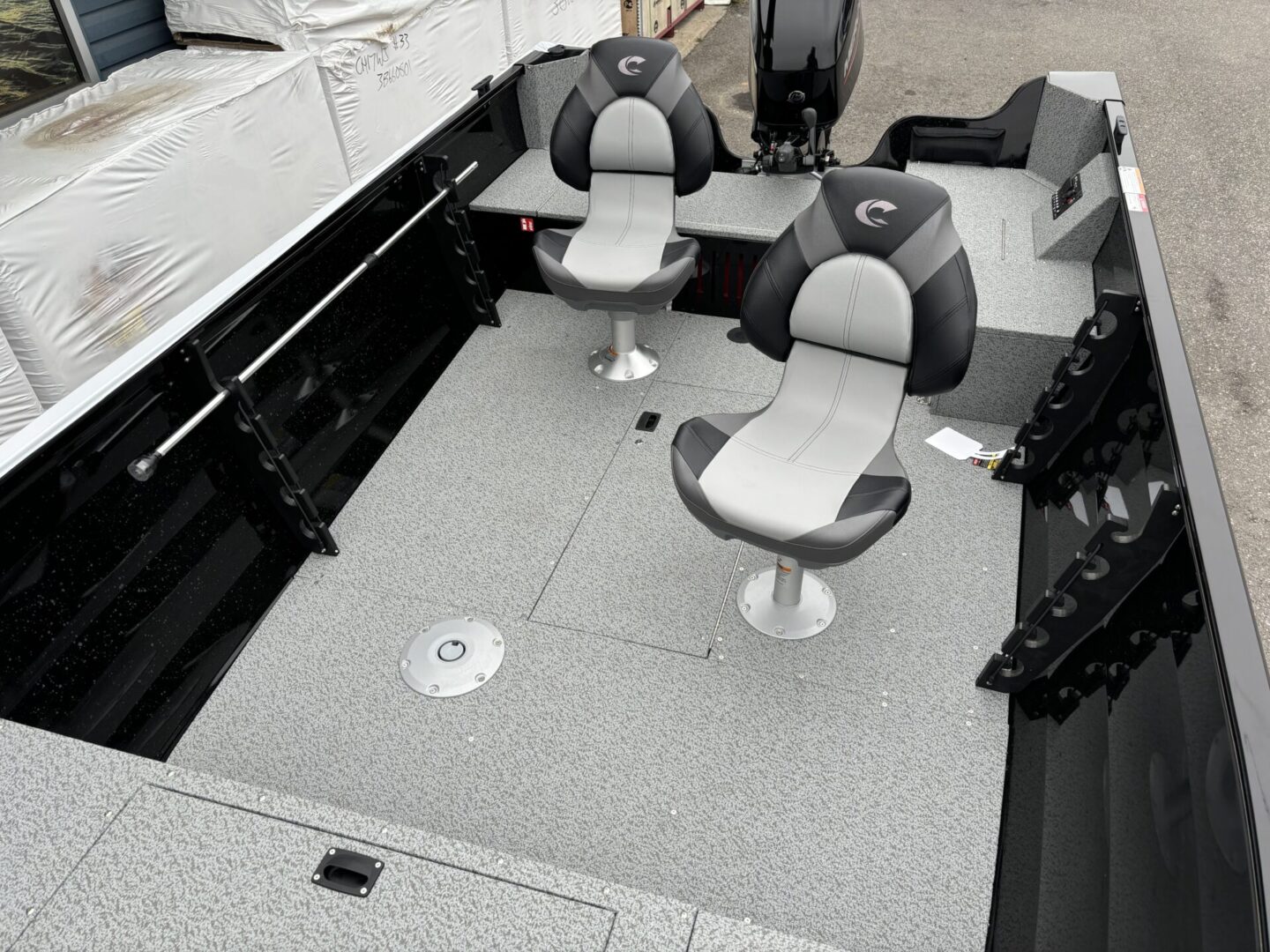 Interior view of a modern fishing boat with two chairs and storage compartments.