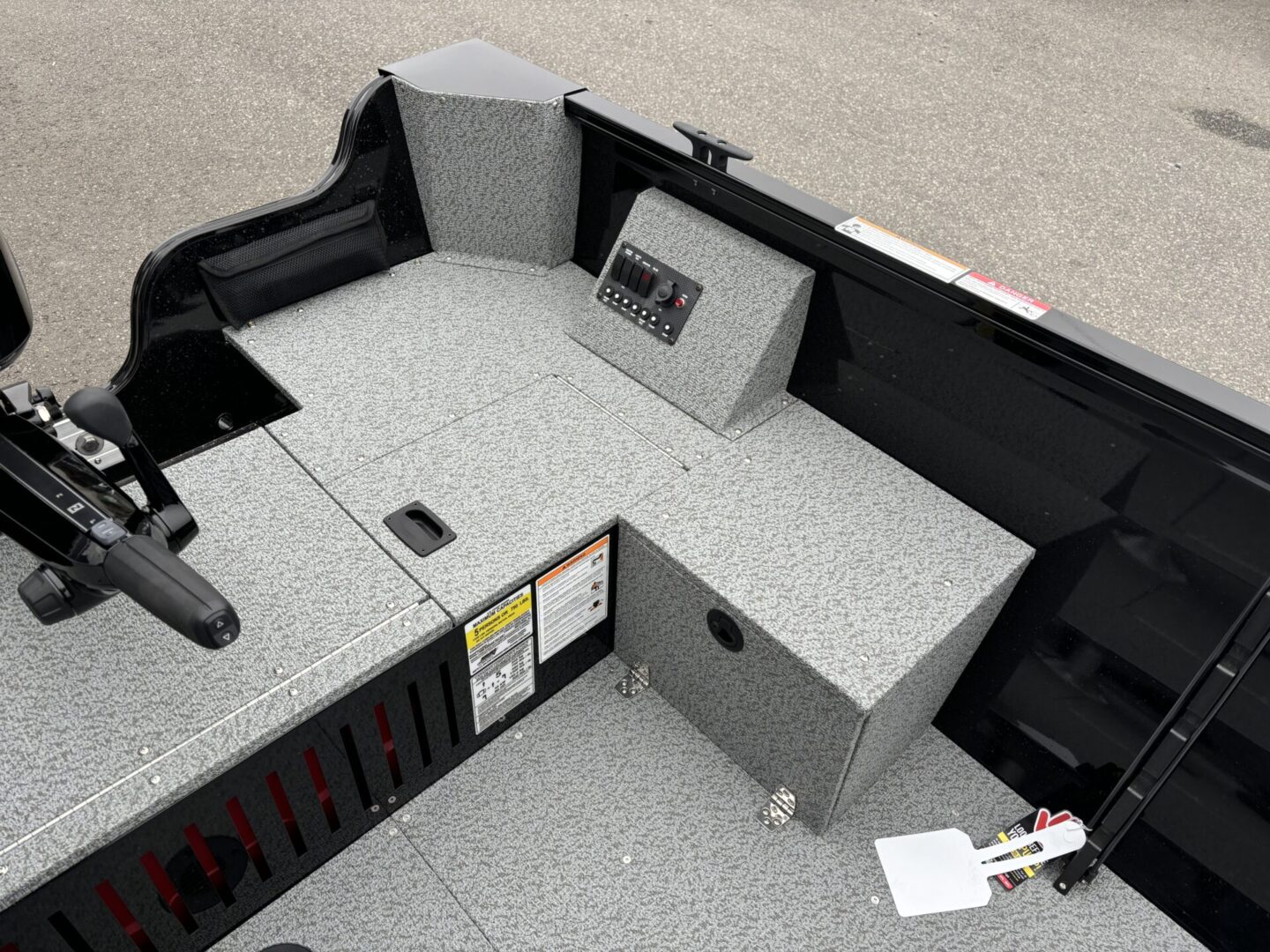 Interior of a modern boat cockpit with control panels and seating.