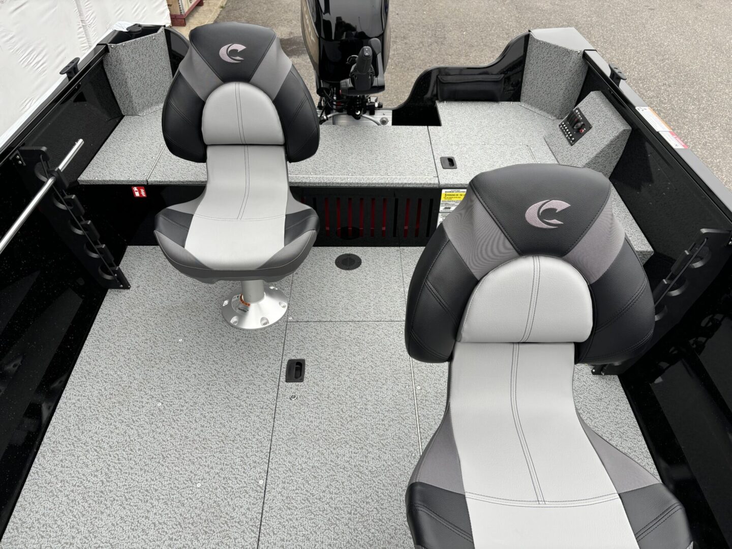 Interior seating area of a modern boat with cushioned chairs and a carpeted floor.