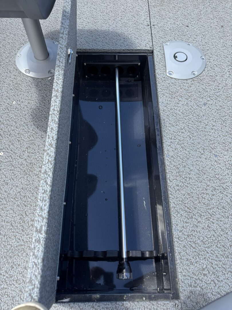 Underdeck rod storage compartment with pole